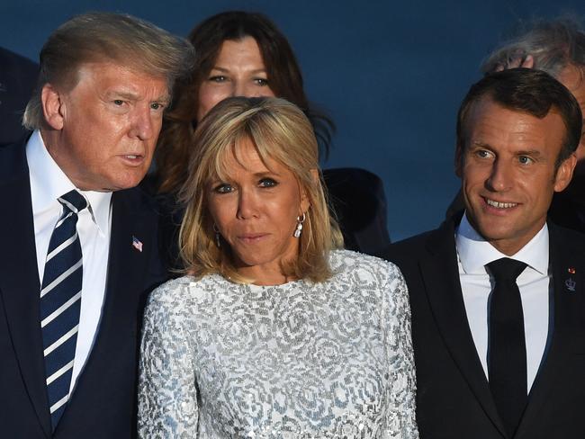 Donald Trump talks to French President's wife Brigitte Macron. Picture: Getty Images