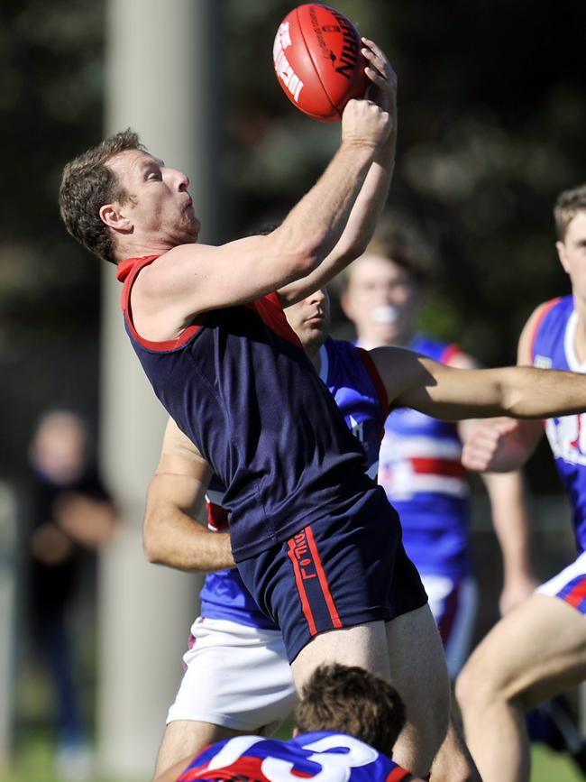 Ryan Flack dishes out a handball during his time at Chelsea Heights.