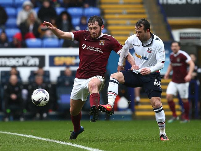 BOLTON, ENGLAND - MARCH 18:  Jak McCourt of Northampton Town contests the ball with Adam le Fondre of Bolton Wanderers to head the ball during the Sky Bet League One match between Bolton Wanderers and Northampton Town at Macron Stadium on March 18, 2017 in Bolton, England. (Photo by Pete Norton/Getty Images) Restrictions  (Photo by Pete Norton/Getty Images)