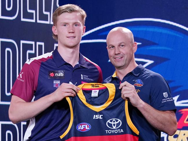 Sixth AFL Draft pick Fischer McAsey is presented with a jersey by Adelaide Crows coach Mathew Nicks during the first round of the 2019 AFL Draft at Marvel Stadium in Melbourne, Wednesday, November 27, 2019. (AAP Image/Michael Dodge) NO ARCHIVING