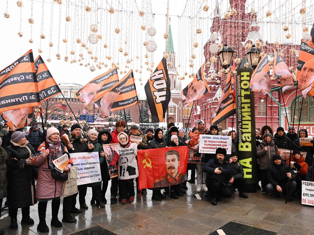 Pro-Putin activists with flags with a portrait of Russian President Vladimir Putin gather in downtown Moscow. Picture: AFP