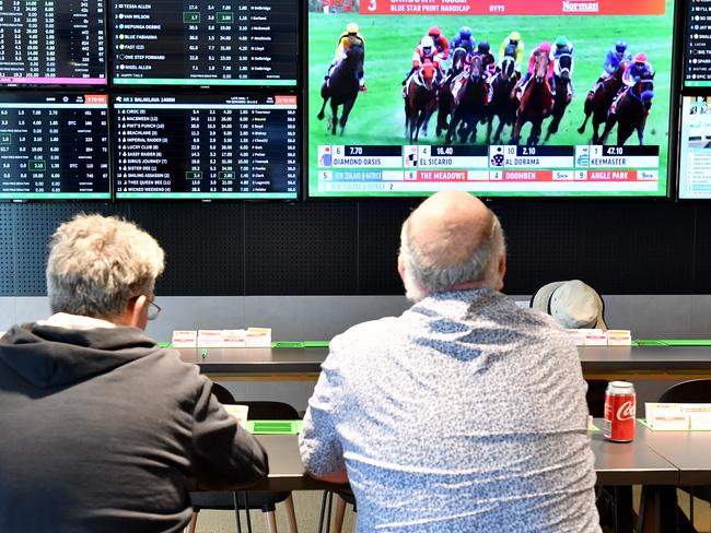 Customer's are seen inside a Tabcorp venue in Brisbane, Wednesday, August 14, 2019. Tabcorp Holdings, which operates in the gambling and media industry announced a net profit after tax (NPAT) result for the full year of $362.5 million and revenue of $5.5 billion from its Lottery, Keno, TAB, and Sky Racing business. (AAP Image/Darren England) NO ARCHIVING