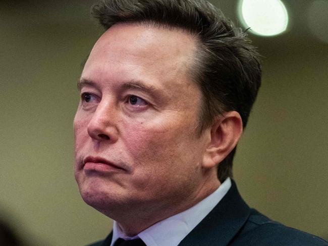 TOPSHOT - Elon Musk listens as US President-elect Donald Trump speaks during a meeting with House Republicans at the Hyatt Regency hotel in Washington, DC on November 13, 2024. (Photo by Allison ROBBERT / POOL / AFP)