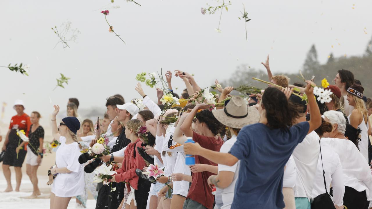 Family and friends of 16-year-old alleged stabbing victim Balin Stewart gather to pay tribute on his home beach at Buddina. Picture: Lachie Millard