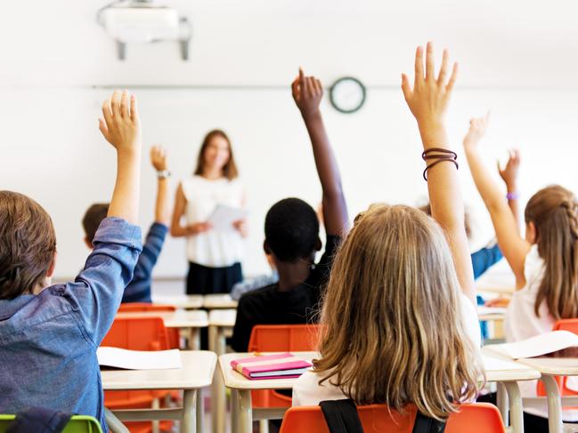 School kids in classroom. Generic (stock) photo of children in a classroom with teacher in background.Picture: iStock