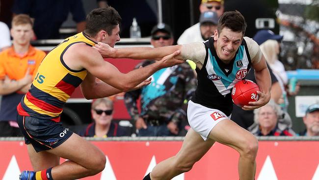 Port Adelaid’s Zak Butters breaks a tackle from Adelaide’s Chayce Jones in last week’s practice match. Picture: AFL Photos via Getty Images