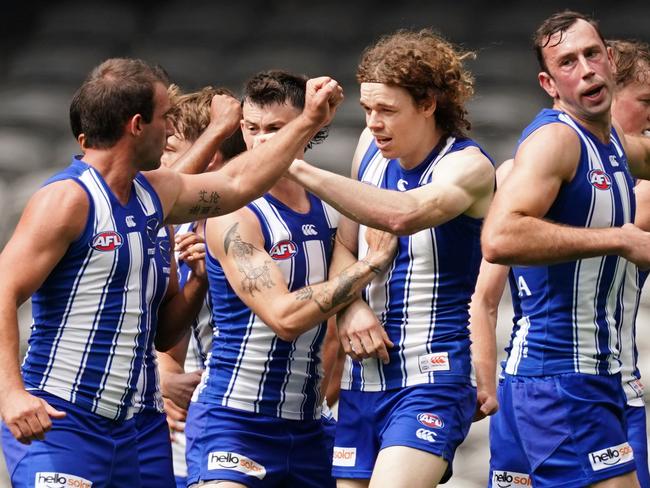 Ben Brown of the Kangaroos is congratulated by his teammates after kicking a goal during the Round 1 AFL match between the North Melbourne Kangaroos and the St Kilda Saints at Marvel Stadium in Melbourne, Sunday, March 22, 2020. (AAP Image/Scott Barbour) NO ARCHIVING, EDITORIAL USE ONLY