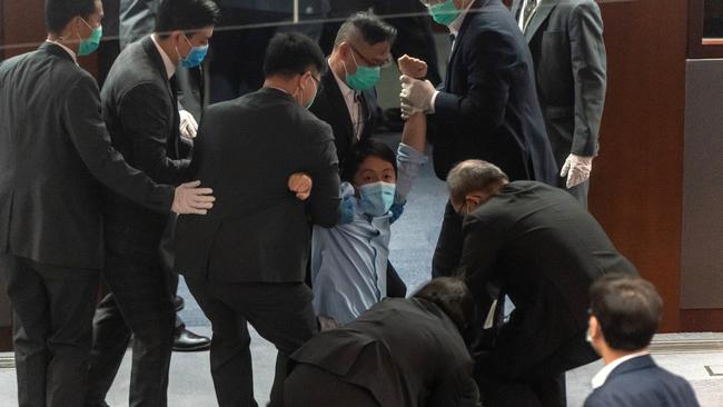 Pro-democracy lawmaker Ted Hui Chi-fung is removed by security during a scuffle with pro Beijing lawmakers at the House Committee's election of vice chairpersons, at the Legislative Council on May 22, 2020 in Hong Kong, China. Picture: Anthony Kwan/Getty Images