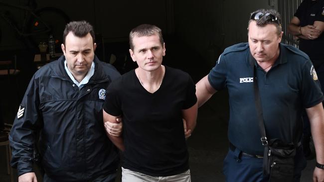 Alexander Vinnik, centre, after his arrest in Greece. Picture: AFP