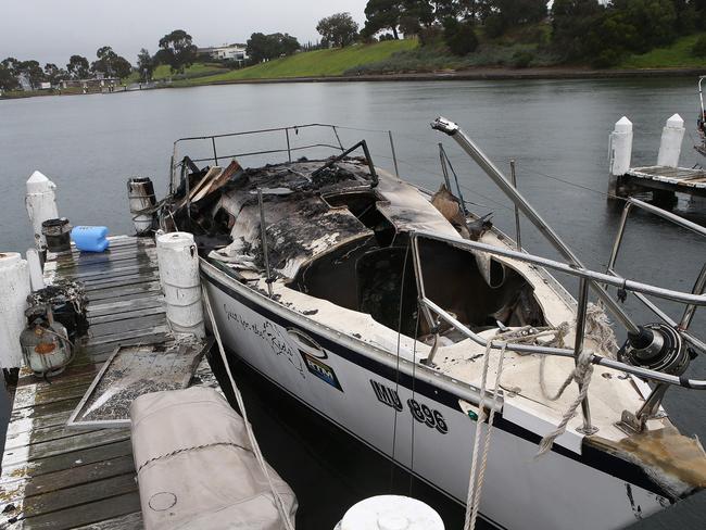 The remains of the yacht where two people died in a fire off a North Geelong pier. Picture: Alison Wynd