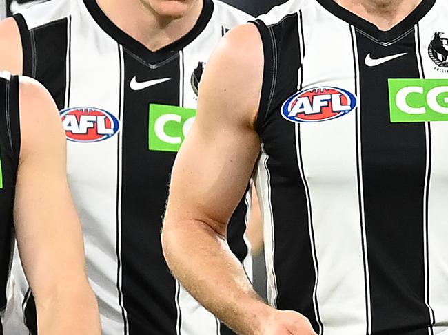 MELBOURNE, AUSTRALIA - AUGUST 22: Chris Mayne of the Magpies (C) shows his emotions as he leaves the field after his last game following the round 23 AFL match between Essendon Bombers and Collingwood Magpies at Melbourne Cricket Ground on August 22, 2021 in Melbourne, Australia. (Photo by Quinn Rooney/Getty Images)