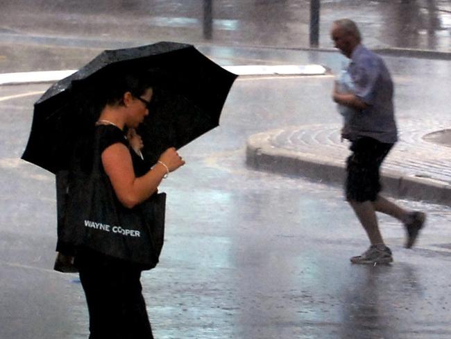 21 Feb 2007. Generic rain in Brisbane City. PicJodie/Richter weather qld woman pedestrian umbrella roads CBD