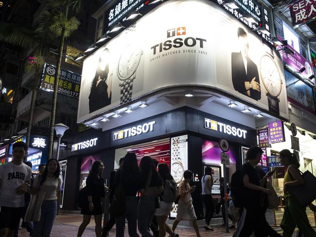 Pedestrians walk past a Tissot SA store in the Causeway Bay district of Hong Kong, China, on Thursday, Aug. 29, 2019. Whether it's glitzy shops in Central or decades-old family businesses along the city's winding streets, retailers of all levels across Hong Kong these days find themselves struggling in much the same way. Photographer: Chan Long Hei/Bloomberg