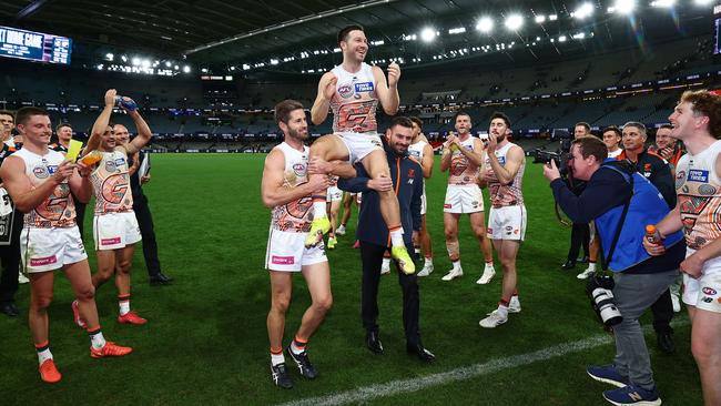 Callan Ward and Stephen Coniglio chair Toby Greene from the ground. (Photo by Morgan Hancock/Getty Images)