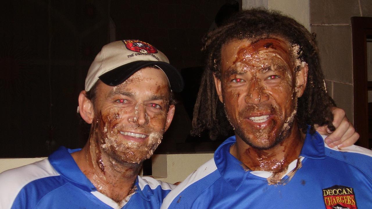 Andrew Symonds and Adam Gilchrist with chocolate cake on their faces, celebrating an IPL win.
