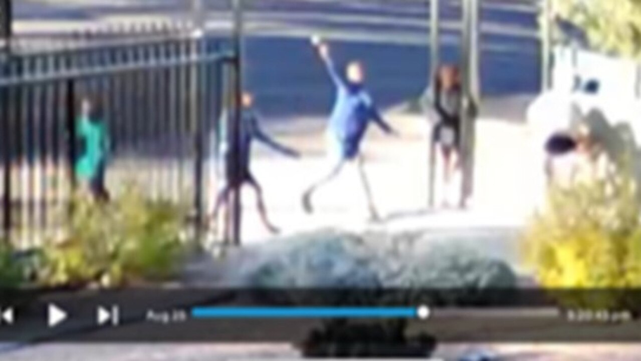 Youth throwing rocks outside a residents house in Larapinta, Alice Springs, a suburb where a tow truck driver lost site in his left eye following an incident on Wednesday evening. Supplied: Bill Yan.