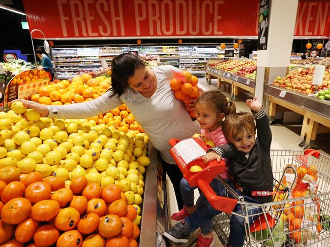 Coles supermarkets have slashed their prices of fruit and vegetables due to an over-supply. Betty Tsougranis (L)stocks up on fresh fruit at Coles East Village in Zetland, pictured with her daughter Ever 3 and friend Ari Farzad 18-months. Picture: Toby Zerna