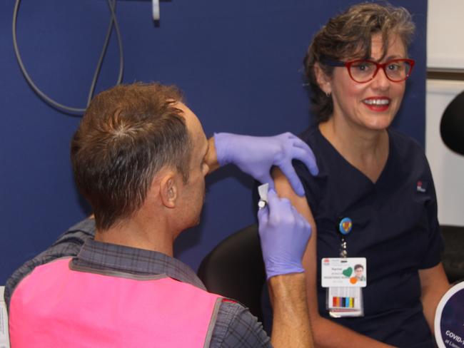 NUMBER ONE: At Lismore Base Hospital, Intensive Care Nurse Rachel Benson was the first health worker in the NNSWLHD to receive a COVID-19 vaccination from Nurse Educator Roger Revill. Photo: Alison Paterson