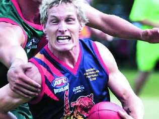 Noosa’s Travis Mills battles to elude a Sandgate opponent at a post-flood fundraiser on March 26. Picture: GEOFF POTTER