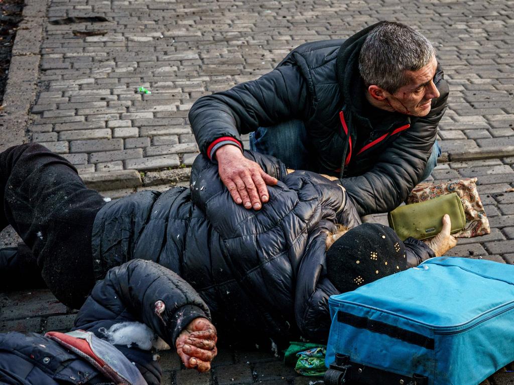 A man helps an injured woman after Russian shelling to Ukrainian city of Kherson on December 24 where five were killed and 20 injured. – Ukrainian President Volodymyr Zelensky on December 24. Picture: AFP