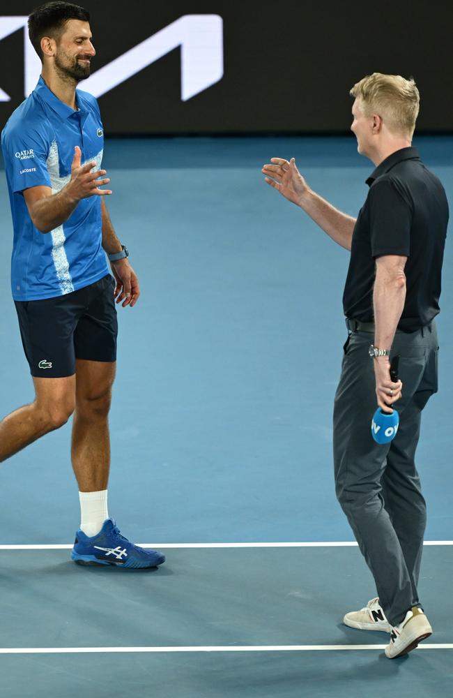 Djokovic greets on-court interviewer Jim Courier after his quarterfinal win. Picture: Hannah Peters/Getty Images