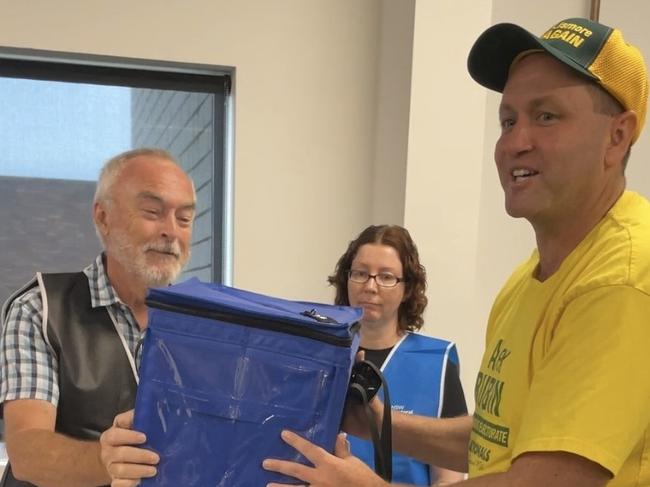 Nationals Candidate for the seat of Lismore Alex Rubin, of Tenterfield, giving the ballot box a lucky shake.