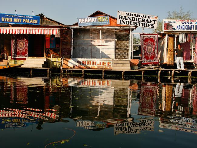 A shop keeper waits for business outside his shop on Dal Lake in Srinigar, Kashmir. Picture: Paula Bronstein/Getty Images