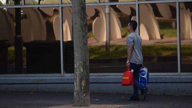 A surveillance image showing Jeng Chiang walking to a post office with shopping bags believed to contain live lizards.