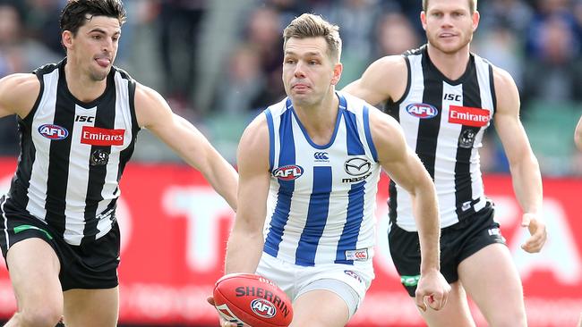 Shaun Higgins evades Magpies Scott Pendlebury and Taylor Adams. Picture: Michael Klein