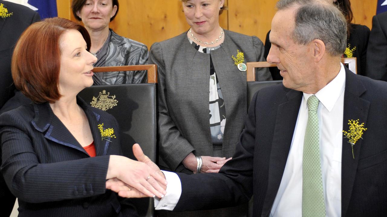 Julia Gillard signing an agreement with then-Greens leader Bob Brown in 2010, as she sought to return to government as a minority. Picture: Alan Porritt/AAP