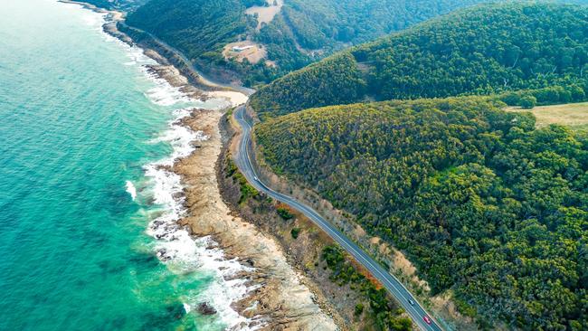 Cars driving on Great Ocean Road, Victoria, Australia - aerial view