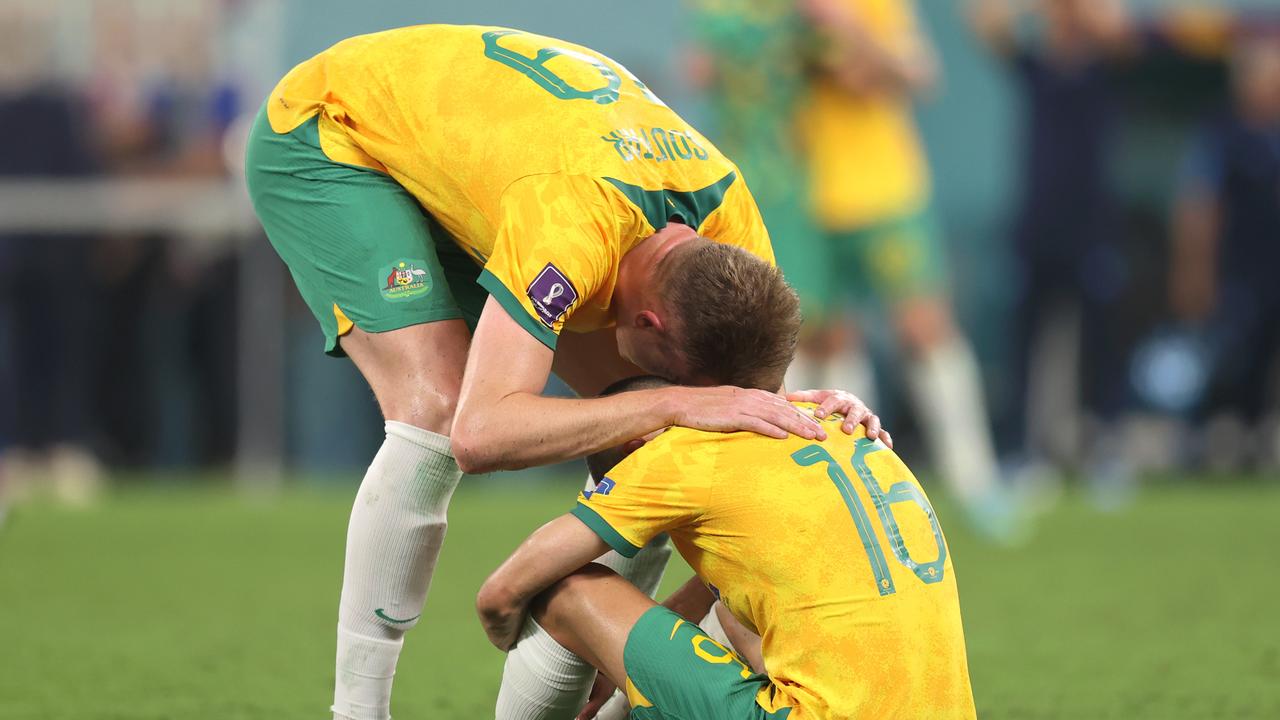 DOHA, QATAR - DECEMBER 03: Harry Souttar and Aziz Behich of Australia look dejected after their sides' elimination from the tournament during the FIFA World Cup Qatar 2022 Round of 16 match between Argentina and Australia at Ahmad Bin Ali Stadium on December 03, 2022 in Doha, Qatar. (Photo by Alex Pantling/Getty Images)