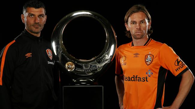Brisbane Roar coach John Aloisi (left) with star recruit Brett Holman with the A-League trophy at the A-League season launch in Melbourne on Wednesday.