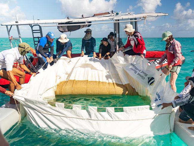 Scientists releasing coral larvae from floating pools near Heron Island, December 2020. Picture: Southern Cross University