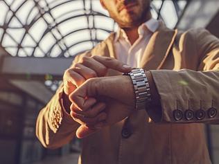 Close up of a man checking the time on wristwatch.