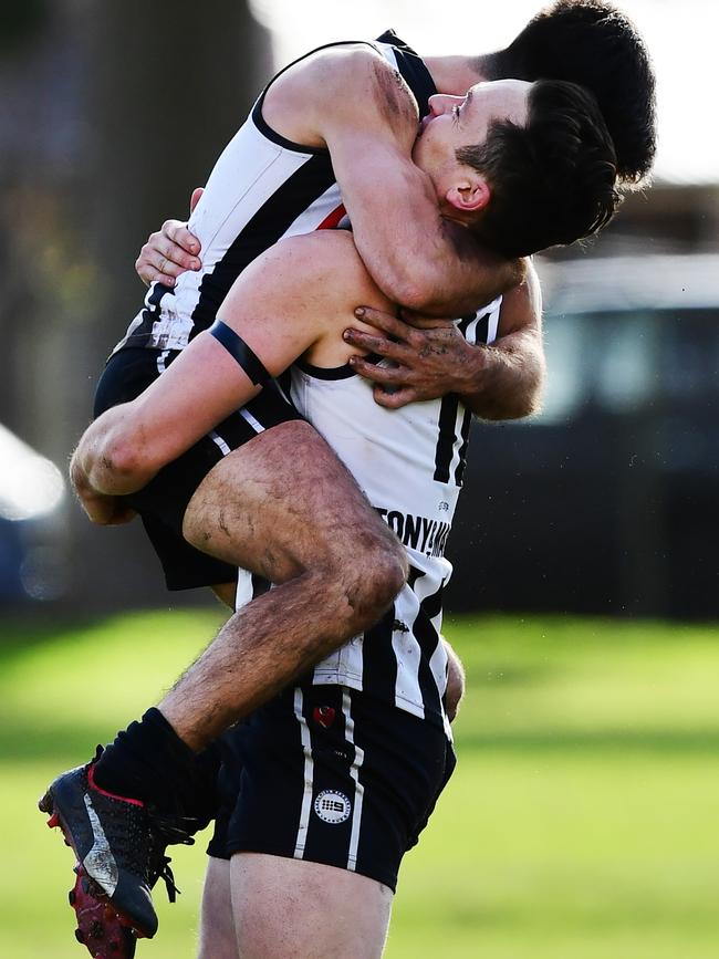 Payneham Norwood Union’s Alex Forster and Anthony Giannini hug after Forster kicked a crucial goal in the Falcon’s win over Port District. Picture: AAP/Mark Brake