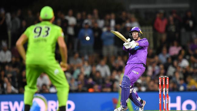 George Bailey hits the ball in the air to be caught out by Chris Green (left) of the Thunder. Picture: AAP/DARREN ENGLAND