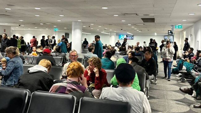 Malaysian Airlines passengers who were forced to disembark their plane after it returned to Sydney Airport wait inside Sydney Airport. Picture: Supplied.