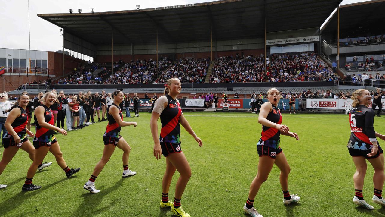 Essendon’s AFLW squad walks off the Windy Hill oval before a record crowd on Sunday. Pic: Michael Klein