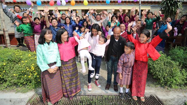 The family reunited: Nima and Dawa's sister, who is also called Nima, 13, Mum Bhumchu, Nima, sister Ugyen, 17, Dawa, dad Sonam, brother Tshering, 7, and sister Phuentsho, 12, celebrate with the entire extended family. Picture: Alex Coppel