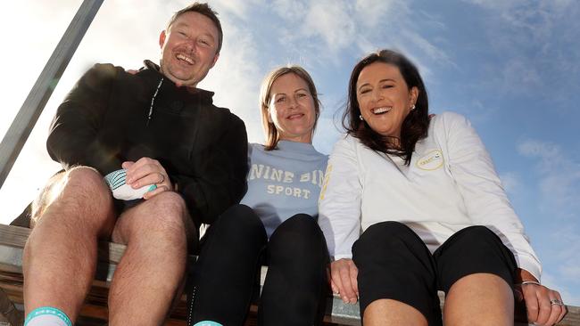 Steigen general manager Nick Chandley, left, widow Katie McMahon and GSMC director Emma Jarman with the Australian Sports Brain Bank fundraising socks. Picture: Alison Wynd