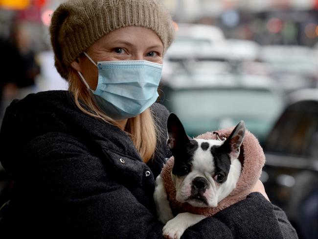 Kate Nelson has started wearing a face mask in public, including when she's walking their dog Roxie along Chapel Street, after the recent spike in COVID-19 cases in Melbourne. Picture: Andrew Henshaw