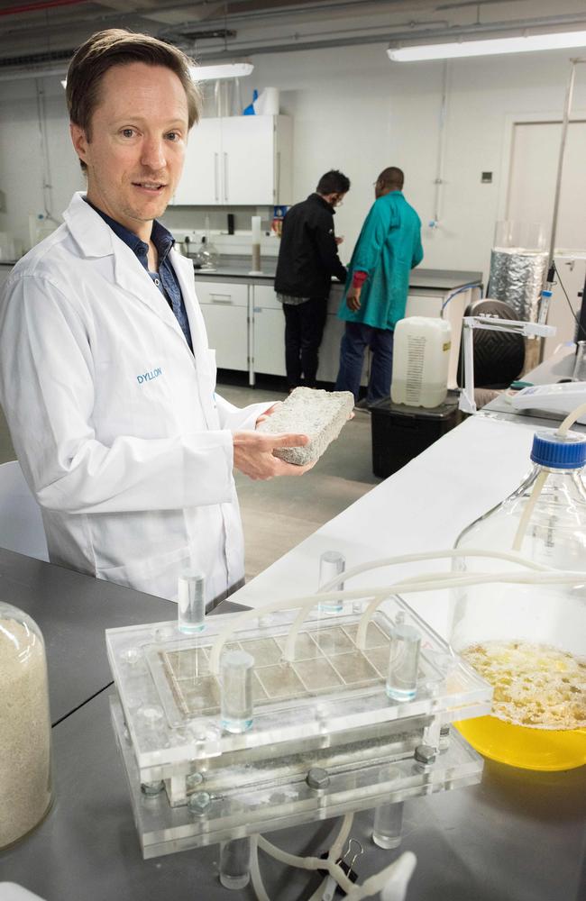 Dr Dyllon Randall, one of the developers of the world's first bio-brick which uses human urine as one of the binding components, shows off one of the bricks in the lab. Picture: Rodger Bosch