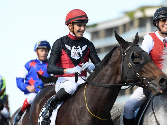 Jockey Jag Guthmann-Chester smiles after riding Manaya to victory in race 4, the Open Handicap, during the Astro Jump Teddy Bears' Picnic race day at Eagle Farm Racecourse in Brisbane, Saturday, July 27, 2019. (AAP Image/Albert Perez)