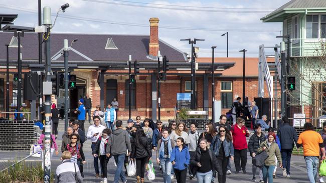 Pedestrians crossing between Ringwood railway station and Ringwood Town Square – two projects which have triggered the suburb’s overhaul. Picture: Andy Brownbill