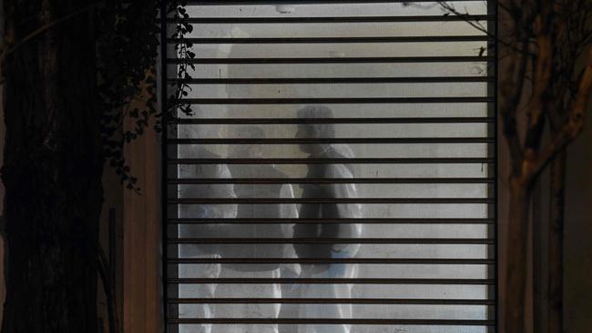 Police members are pictured through a window inside the residence of the Saudi consul to Istanbul on October 17, 2018, as they investigate into the disappearance of Saudi journalist Jamal Khashoggi at the kingdom's consulate in the city. - A team of a dozen police and prosecutors, including forensics experts in white overalls, entered the residence of Mohammed al-Otaibi, a day after he flew out of Istanbul for Riyadh. Earlier in the day, a Saudi delegation had also arrived at the building to take part in what is presented as a joint search with their Turkish counterparts. Turkish police had searched on October 15 the consulate building itself for over eight hours, taking away soil and DNA samples for further examination. Khashoggi, a former regime insider who became critical of Saudi Arabia's Crown Prince Mohammed bin Salman, wrote articles for titles including the Washington Post. He has not been seen since he stepped inside the Saudi consulate in Istanbul on October 2. (Photo by OZAN KOSE / AFP)