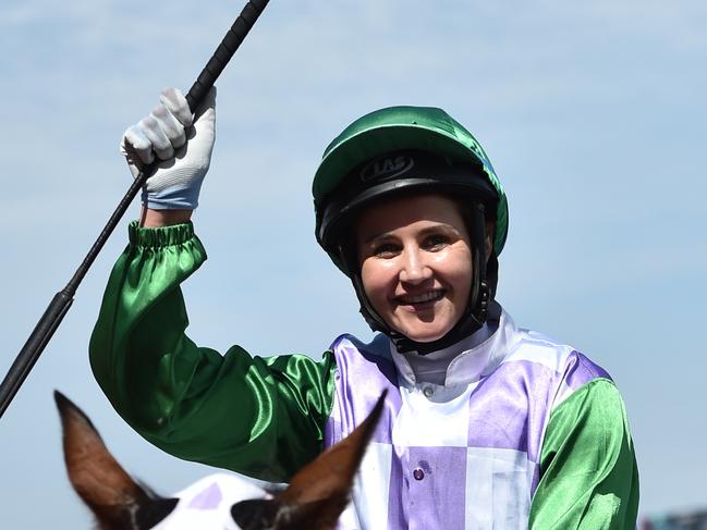 Michelle Payne celebrates as she returns to the mounting yard after she rode Prince of Penzance to victory in the Melbourne Cup at Flemington Racecourse in Melbourne, Tuesday, Nov. 3, 2015. (AAP Image/Julian Smith) NO ARCHIVING, EDITORIAL USE ONLY