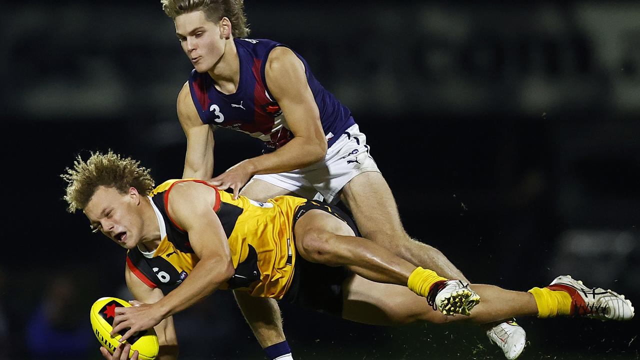 Taj Campbell-Farrell of the Stingrays is tackled by Will Ashcroft of the Dragons.