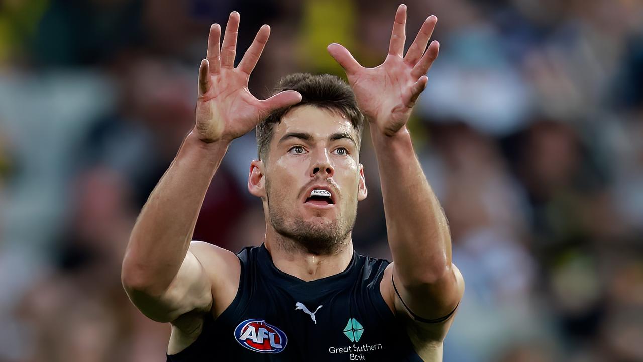 George Hewett is under a cloud ahead of Thursday night’s match against Geelong, with his injured hand to be assessed at training on Wednesday. Picture: Dylan Burns / Getty Images