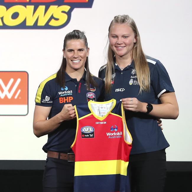 Chelsea Randall of the Crows presents new teammate Montana McKinnon with her guernsey at the AFL Draft. Picture: Michael Willson/AFL Photos via Getty Images